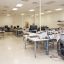An engineering room with desks and devices used to tune satellite communication equipment.